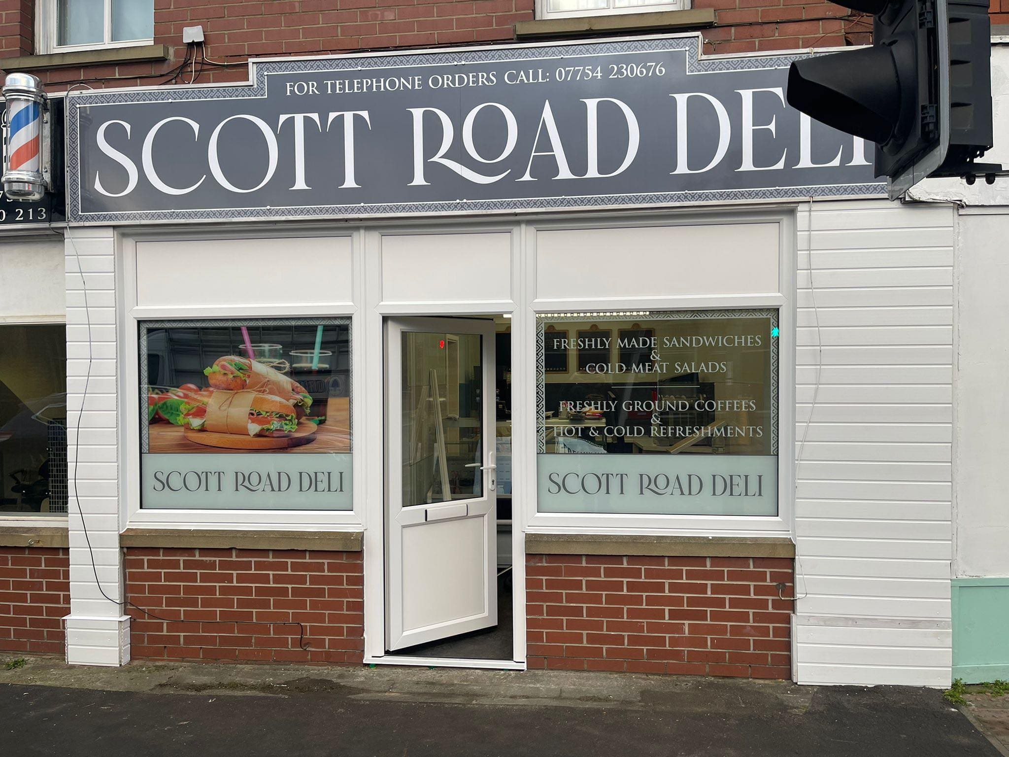 Full exterior shot of a shop, likely a deli, called 